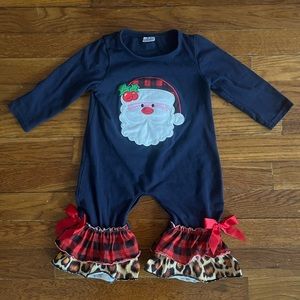 Santa onesie, size 6-12 months. Flare at the foot with ruffle and bow detail.